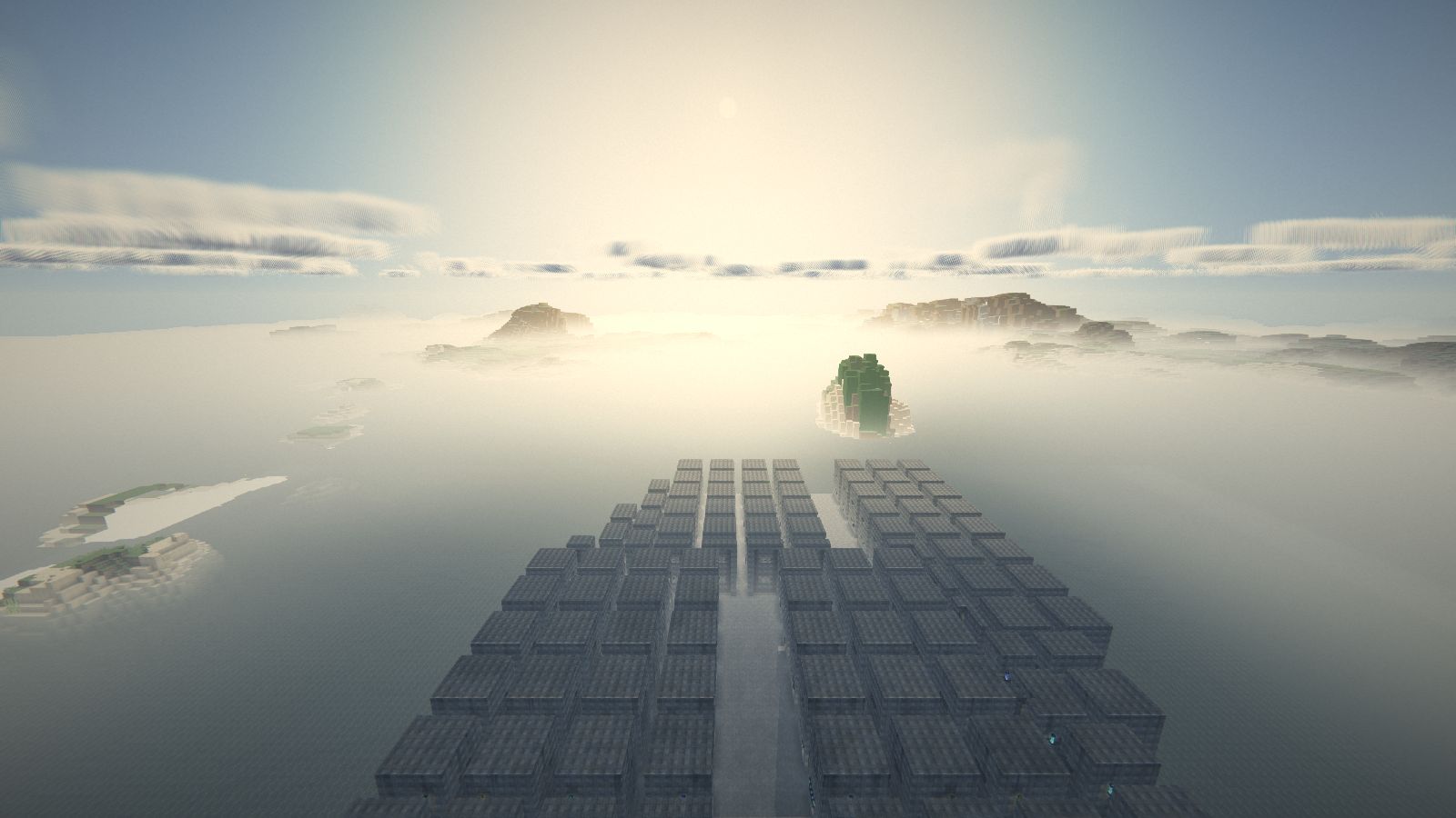 Vue en hauteur au lever du soleil, la brume couvre le sol et les îles en émergent